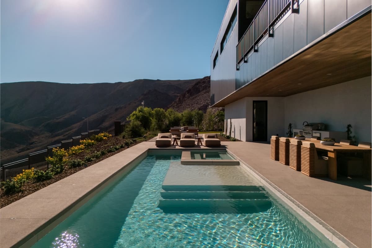 Luxury desert home with a private pool, outdoor kitchen, and panoramic mountain views.