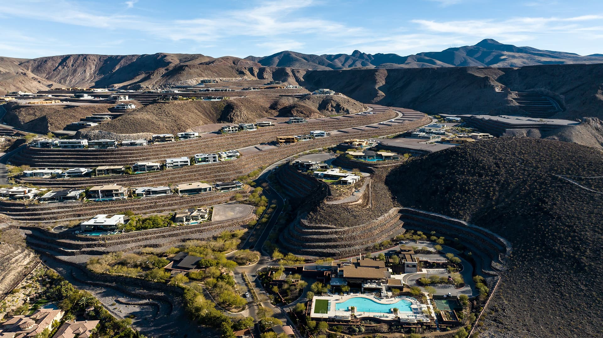 Aerial view of Ascaya’s terraced desert community, where contemporary custom homes are thoughtfully integrated into the mountainside landscape beneath the McCullough Range.