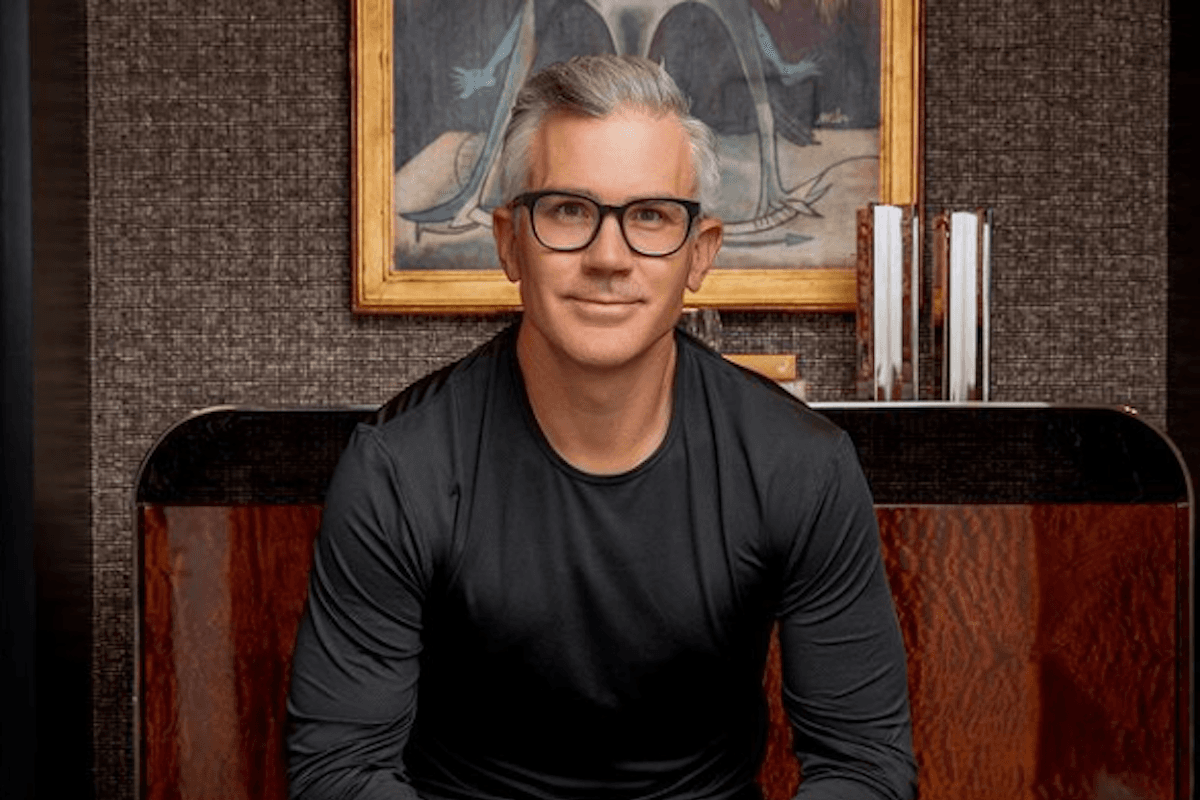Portrait of smiling professional man wearing glasses indoors.