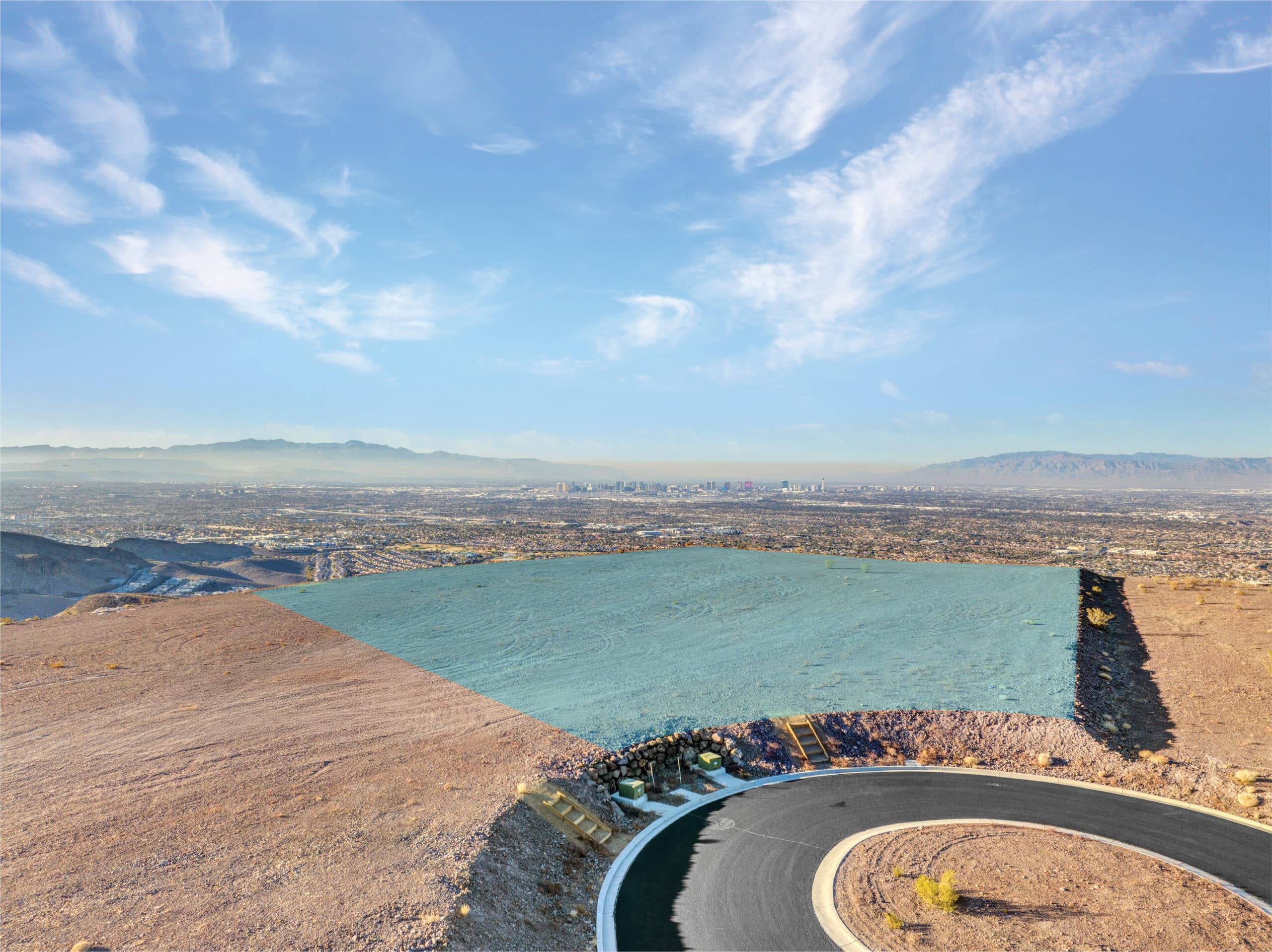 Aerial view of a modern hillside residential development in a desert landscape.