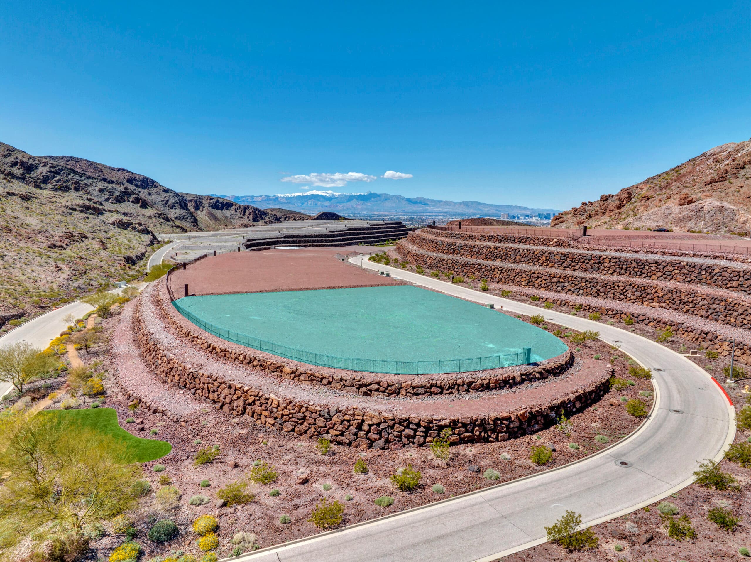 Aerial view of homesite lot outlined within a desert mountainside community development