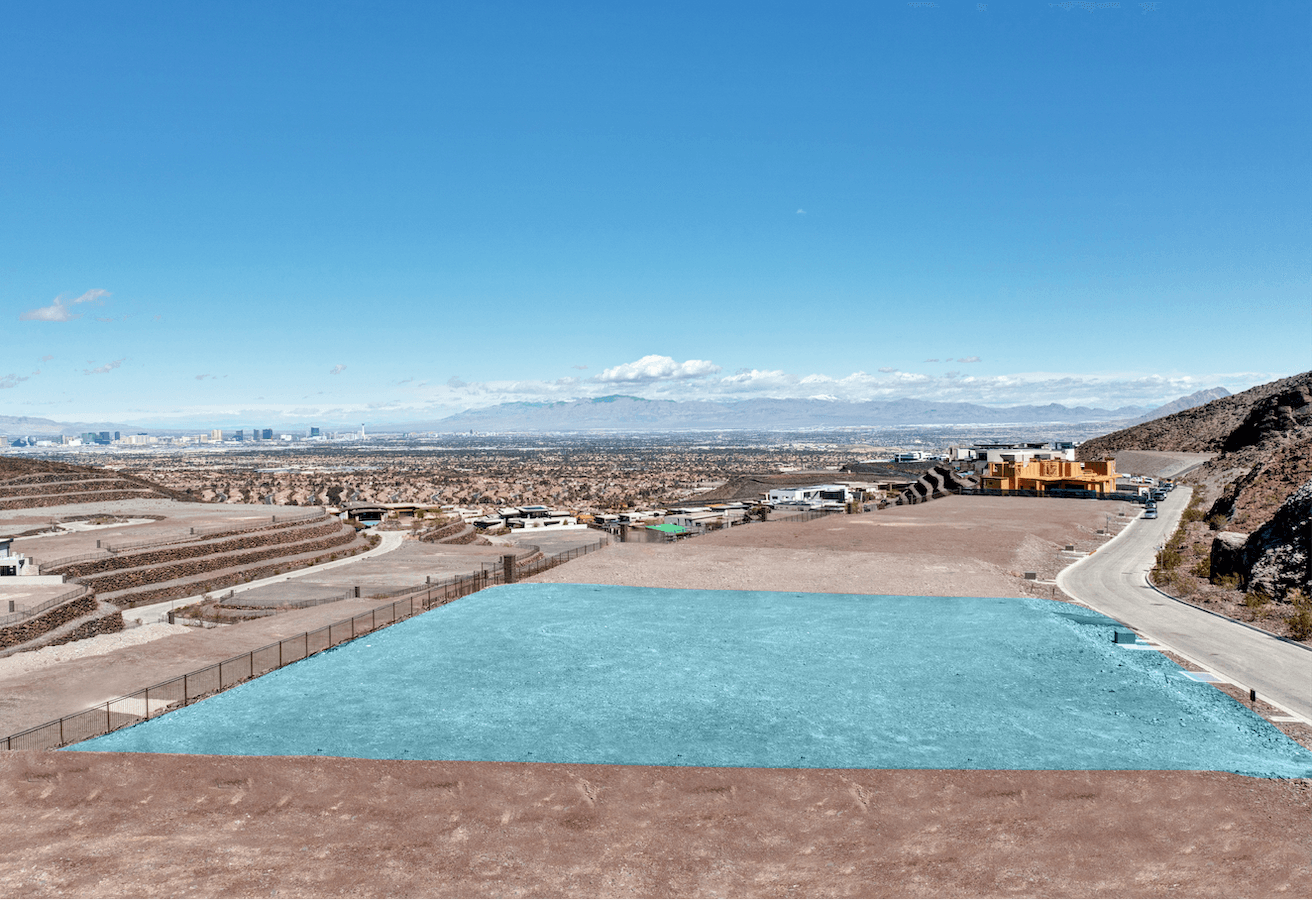 Aerial view of a modern hillside residential development in a desert landscape.